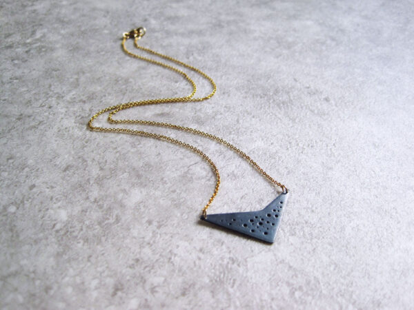 Oxidised silver geometric hole-patterned pendant on fine gold-filled chain